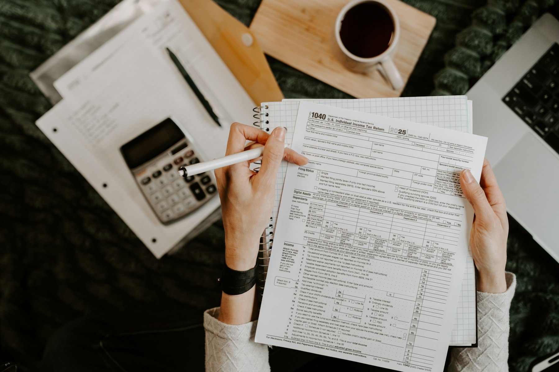 Accountant reviewing financial paperwork and tax documents