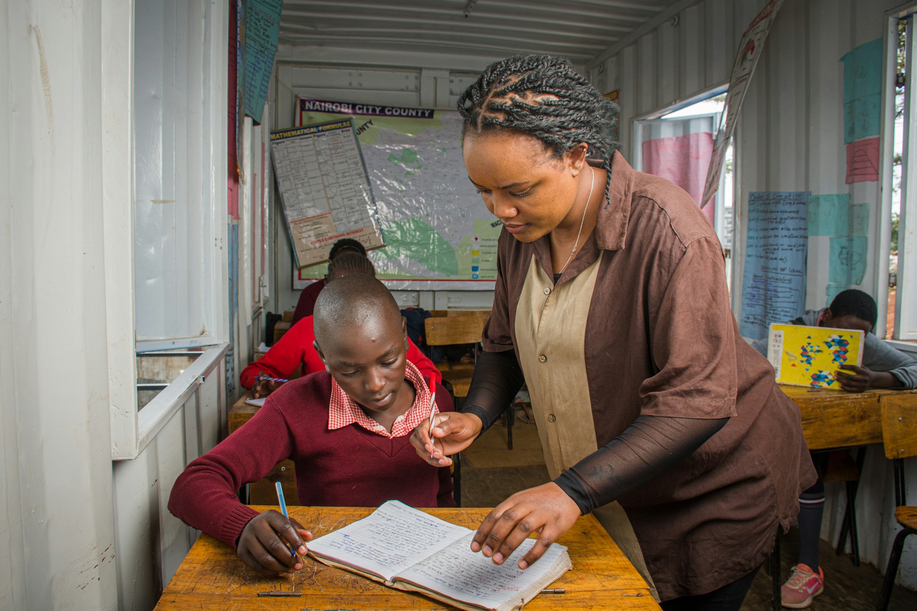 Teacher helping a student during a classroom training session